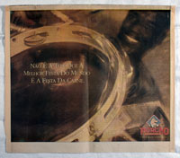 Porcão Restaurant:<br />Advertisement with image of a member of a<br />samba school's percussion section.